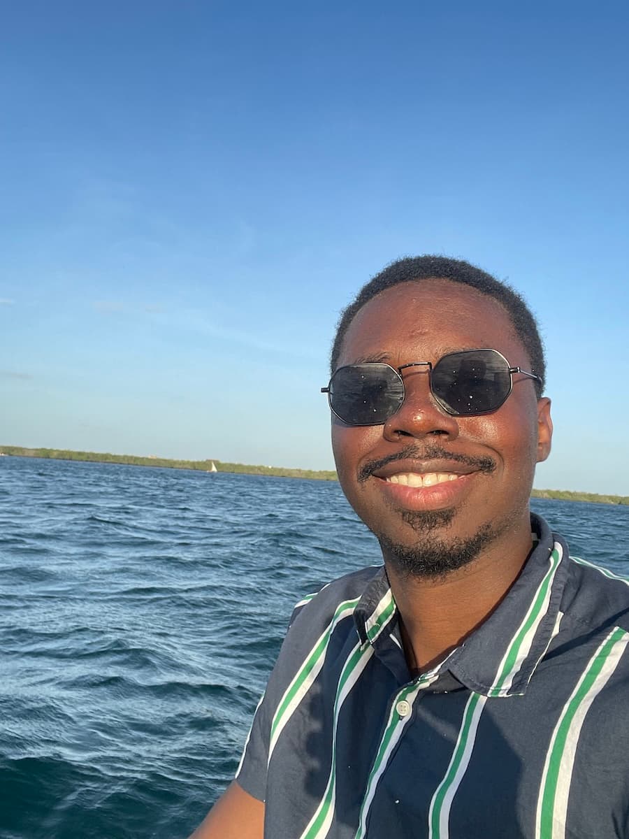 A photo of myself, with a body of water and the horizon as the background
